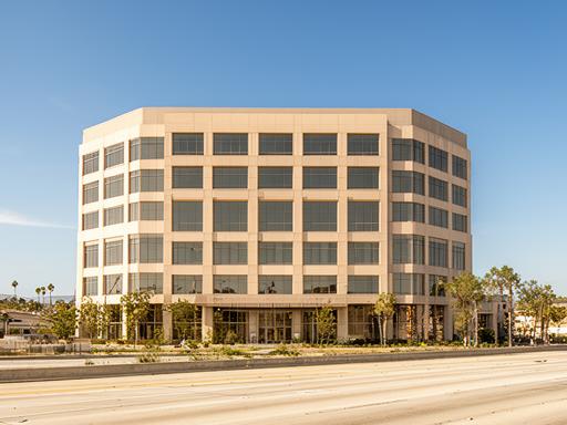 Modern office building along San Diego Freeway in Hawthorne California with clear blue sky